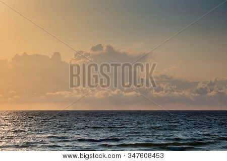 Evening Sky With Cumulus Clouds Sky Above Sea Surface In Sunset. Cuculus Cloudscape With Sunlight Ov