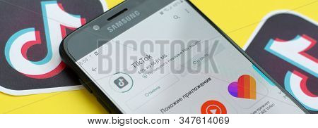 Tiktok Application In Playmarket On Samsung Smartphone Screen On Yellow Background. Tiktok Is A Popu