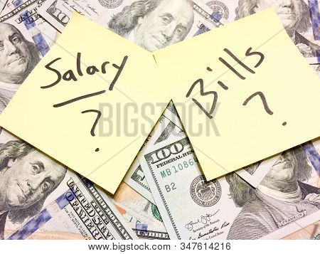 American Cash Money And Yellow Paper Note With Text Salary And Bills With Question Marks In Black Co