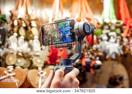Germany, Munich - December 20, 2018: Close-up Of Man Blogger Hands Shooting Video On Smartphone Ipho