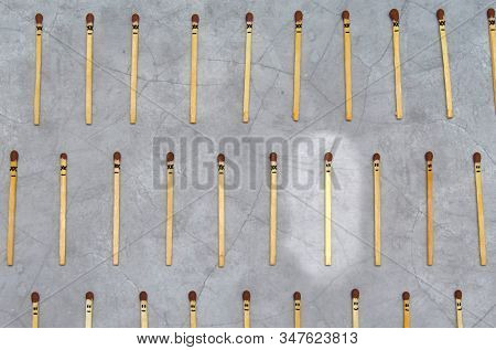 Many Matches On Concrete Background With Faces, Concept Of Virus Infection