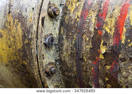 Bolt Coupling On The Old Metal Pipe (tube). Pipeline. Cracked And Damaged Yellow And Red Paint On Th