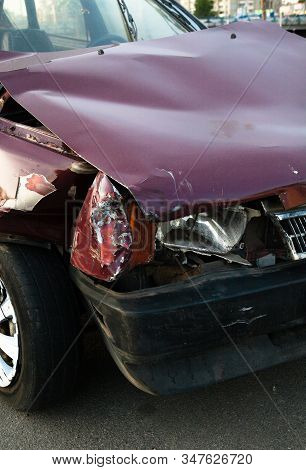 Damaged Car After The Accident. Wrinkled Metal Hood. Broken Engine.