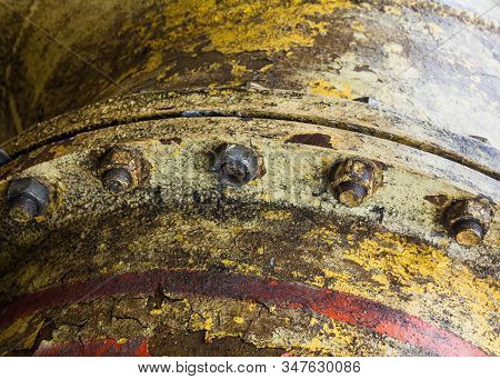 Bolt Coupling On The Old Metal Pipe (tube). Pipeline. Cracked And Damaged Yellow And Red Paint On Th