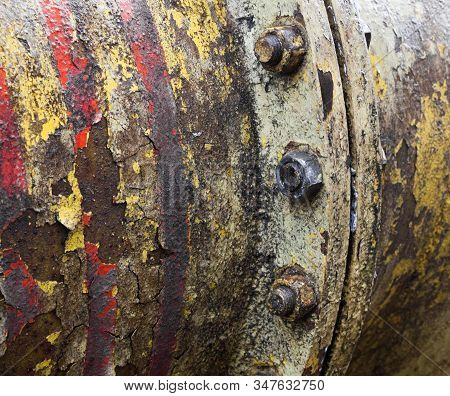 Bolt Coupling On The Old Metal Pipe (tube). Pipeline. Cracked And Damaged Yellow And Red Paint On Th