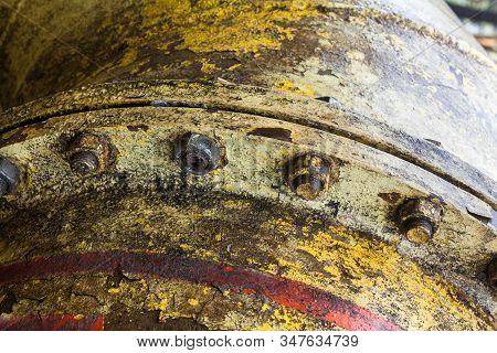 Bolt Coupling On The Old Metal Pipe (tube). Pipeline. Cracked And Damaged Yellow And Red Paint On Th