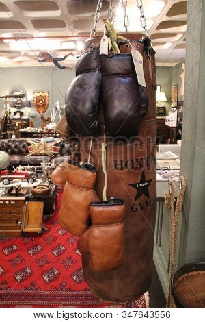 Porto, Portugal- January 3, 2020: Vintage Sack And Boxing Gloves For Sale In An Old Warehouse Called