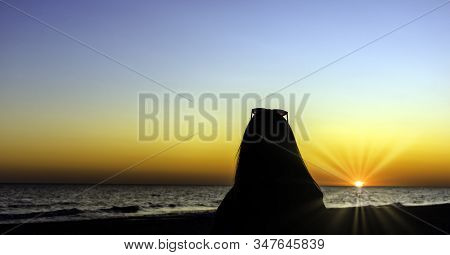 Silhouette Of A Girl With Sunset Over Baltic Sea In Lubiatowo, Pomerania, Poland