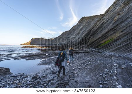 Deba, Gipuzkoa / Spain »; January 26, 2020: Two Young People Exploring The Geopark Of The Sakoneta C