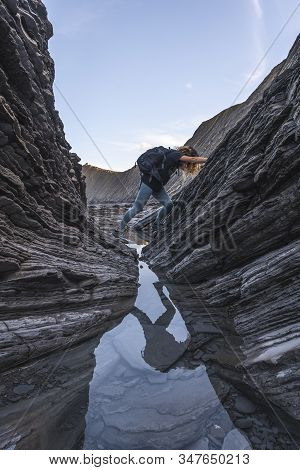 Deba, Gipuzkoa / Spain »; January 26, 2020: A Young Woman Exploring The Sakoneta Coast Geopark Among