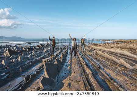 Deba, Gipuzkoa / Spain »; January 26, 2020: Three Young People On The Coast Of Sakoneta After Finish