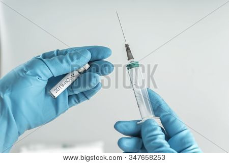 Medicine Bottle With 2019-ncov Vaccine And Disposable Syringe Closeup In The Doctor Hands