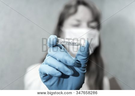 Nurse Wearing Mask Holding A Vaccine For New Rapidly Spreading Coronavirus 2019-ncov