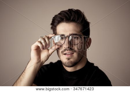 Portrait Of Young Handsome Manly Man With Glasses Looking Sexy And Sensual With Beautiful Dark Ayes.