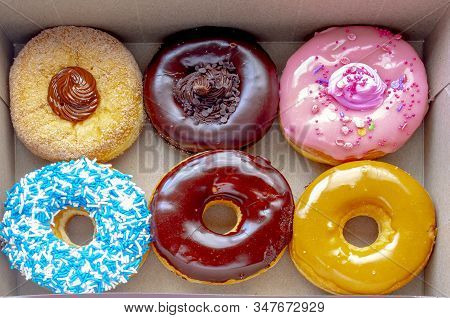 Top View Inside Of A Tim Hortons Six Donuts Box, With A: Dulce De Leche, Chocolate Truffle, Strawber