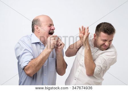 Sick Bald Caucasian Man Holding Napkin Or Tissue, Trying To Cover Mouth While Sneezing