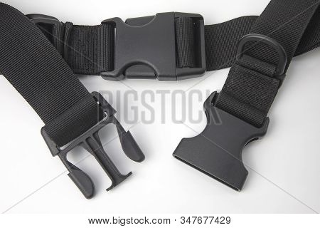 Black Plastic Fastex Clip For Backpacks On A White Background. Items Of Clothing And Equipment