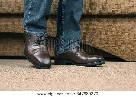 Men's Legs In Jeans Shod In Classic Brown Shoes