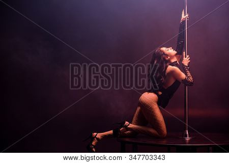 Sexy Young Stripper With Closed Eyes Pole Dancing On Black With Smoke