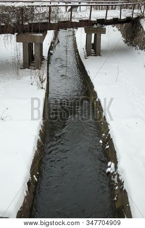 Urban Stream In Winter. The Lybid River (kyiv, Ukraine) In The Snow.