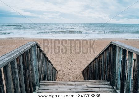 Stairs Leading Down To The Sandy Beach At Islantilla Spain During A Cloudy, Cold Winter Day