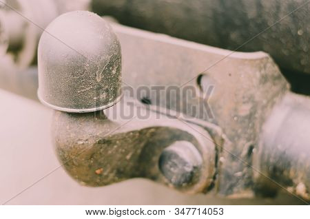 Old Tow Hitch For Towing A Trailer. A Dirty Rusty Trailer Hitch Is Mounted On The Machine. Rear Powe