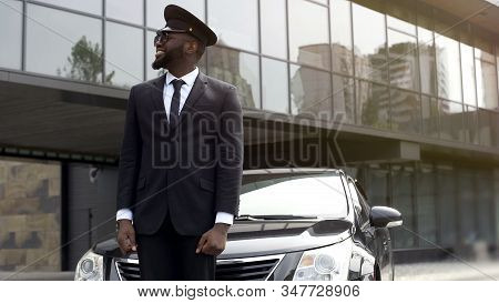 Airport Taxi Driver Waiting For Client Arrival, Transfer Service At Luxury Hotel