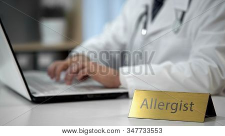 Male Allergist Prescribing Medication In Clinic, Keeping Records, Health Care