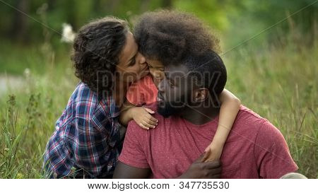 Caring Parents Comforting And Calming Their Little Daughter, Childish Whims