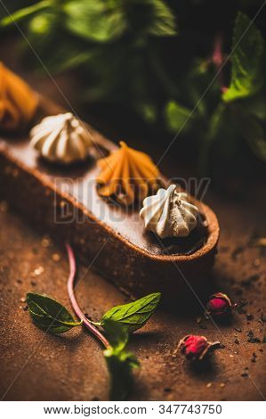 Caramel Tart Dessert With Belgium Chocolate And Swiss Merenge, Close-up