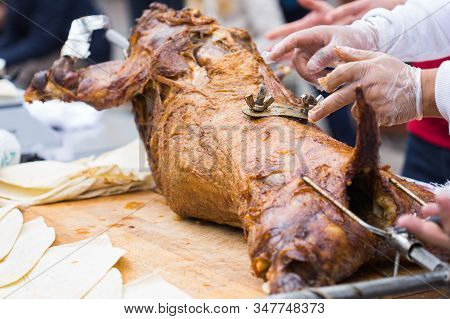 The Carcass Of A Lamb Is Roasted On A Spit. Close-up Carcass Of A Sheep That Is Roasting On The Spit
