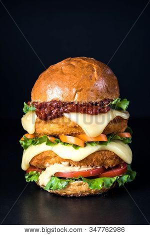 Fresh Tasty Burger On A Black Background. Copy Space