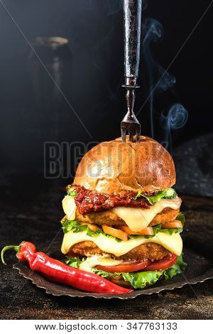 Fast Food. Big Burger With Beef And  Beer. Antique Fork And Tray. On A Wooden Background. Copy Space