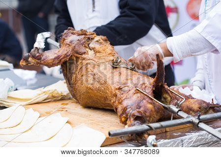The Carcass Of A Lamb Is Roasted On A Spit. Close-up Carcass Of A Sheep That Is Roasting On The Spit