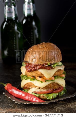 Homemade Chicken Burger With Fried Egg Tomato Lettuce Cucumber Dripping Mozzarella On Cutting Board 