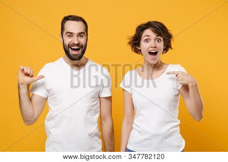 Excited Young Couple Friends Bearded Guy Girl In White Blank Empty T-shirts Posing Isolated On Yello
