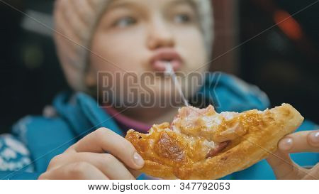 Child Eat Pizza Cheese Four. Close Up Of Young Girl Woman Eating Pizza And Chewing In Outdoor Restau