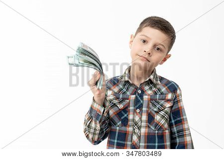 Confident Calmy Little Boy In Shirt Holds Banknotes In His Hand And Looking At The Camera Isolated O