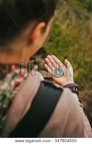 Women Check Direction At The Compass In Her Hand To Find Right Hiking Path
