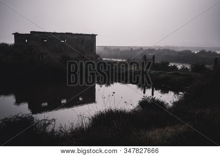 A Dark Fearful Landscape With An Old Abandoned Residential Building On A Misty Morning With A Pond I