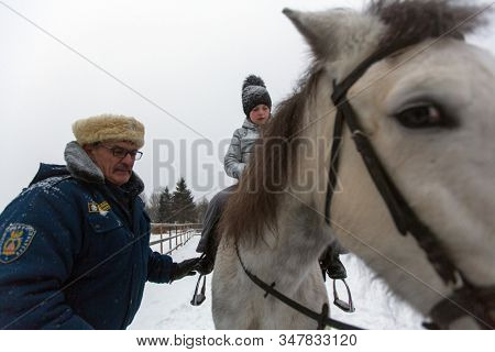 PODPOROZHYE, RUSSIA - JAN 21, 2018: Training of children riding in the framework of revival program of the Cossacks in the Leningrad region. Cossacks in St.Petersburg began its revival in 1990.
