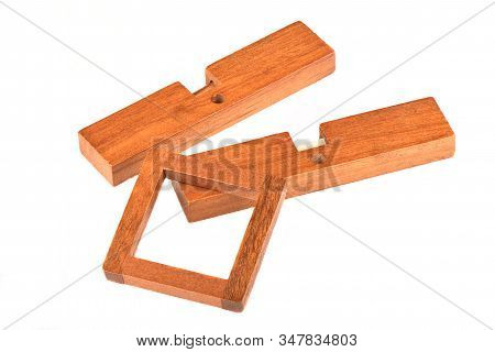 Dismantled Wooden Cross Puzzle Isolated On A White Background.