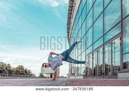 Man Stands On One Arm, Young Guy Dancer, In Summer In City, Dancing Street Dances, Modern Style Of Y