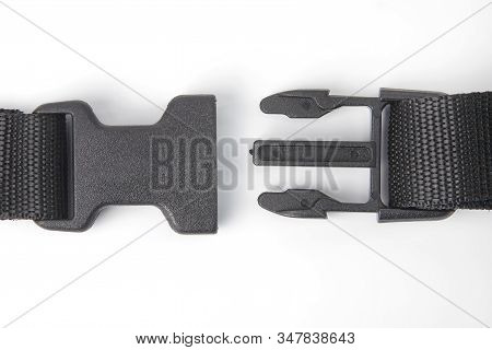 Black Plastic Fastex Clip For Backpacks On A White Background. Items Of Clothing And Equipment