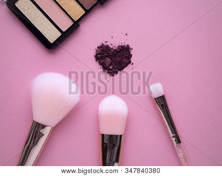 Cosmetic Nylon Makeup Brushes On Pink Background With Crushed Plum Shimmer Eyeshadows In Heart Shape
