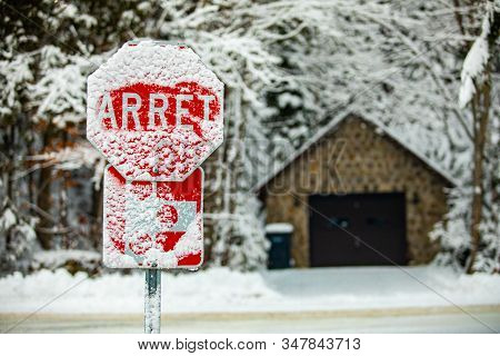 French Canadian Traffic And Highway Signs Are Barely Readable After A Heavy Winter Snowstorm, Covere