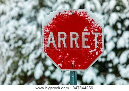 A Close Up Selective Focus Shot Of A Traffic Sign Saying Arret, French For Stop, Seen On A Street In