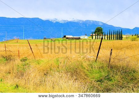 Rural Grasslands Surrounding A Ranch With Snow Capped Mt San Gorgonio Beyond Taken On A Field In Bea