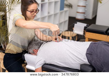 Man Having Chiropractic Back Adjustment. Physioterapy, Osteopathy, Alternative Medicine Pain Relief 