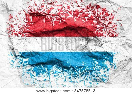 The National Flag Of The Luxembourg Is Painted On Crumpled Paper. Flag Printed On The Sheet. Flag Im